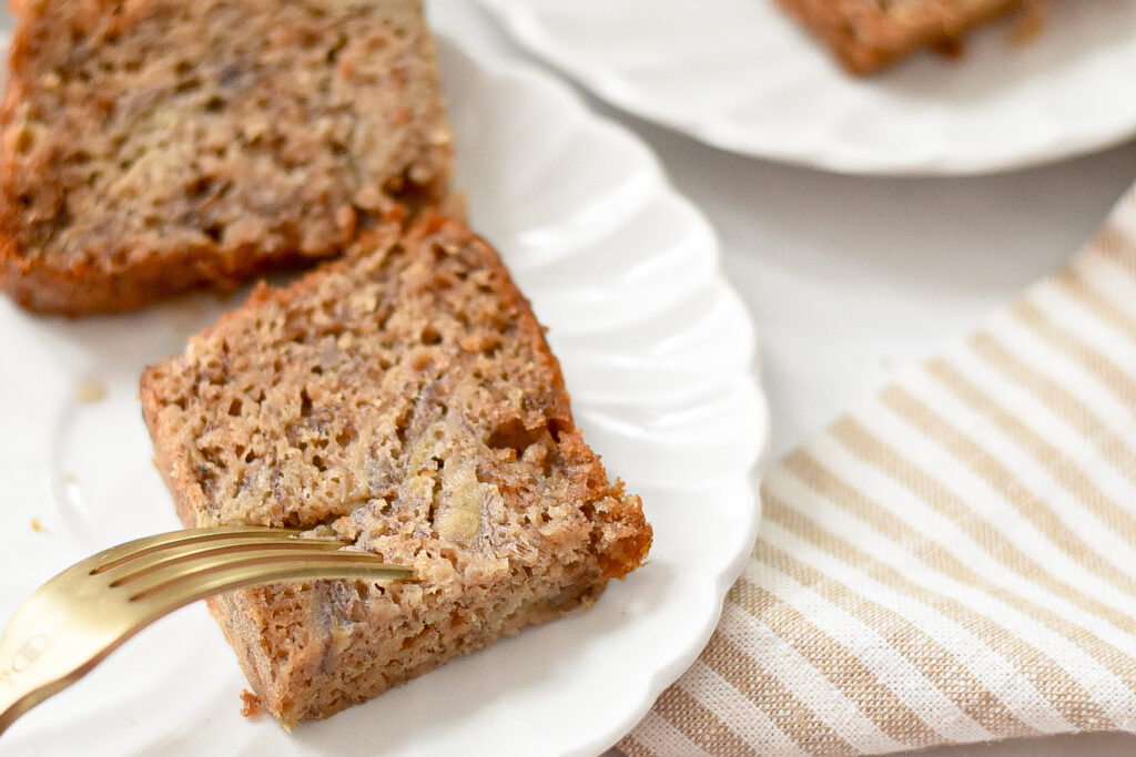 moist low sugar banana bread, with a fork slicing into it