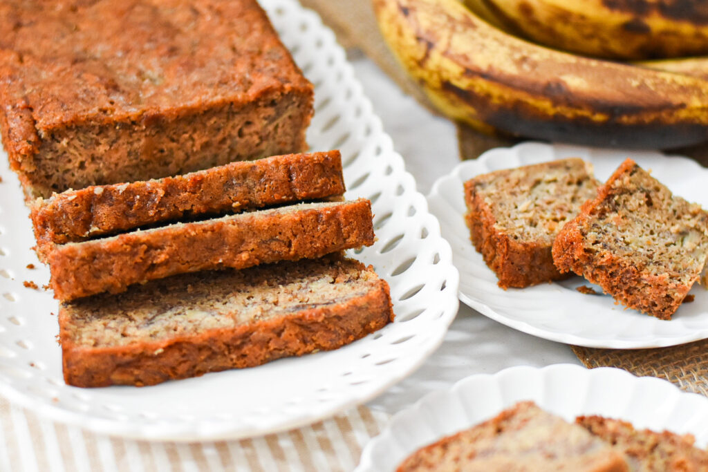 loaf of moist low sugar banana bread on a plate