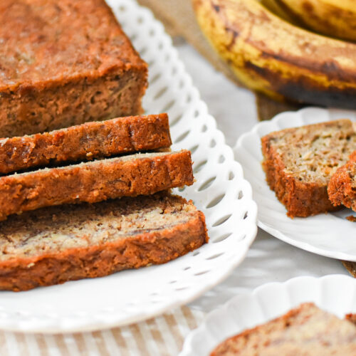 loaf of moist low sugar banana bread on a plate