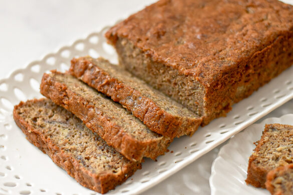 moist low sugar banana bread on a white platter