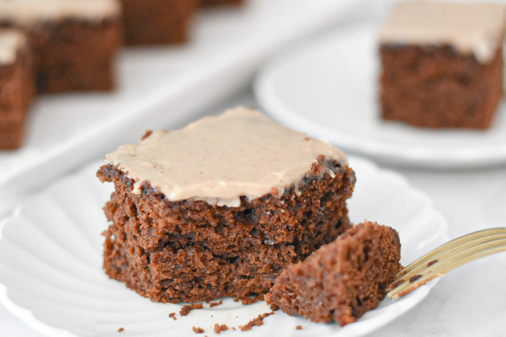 A slice of moist gingerbread snacking cake with maple icing