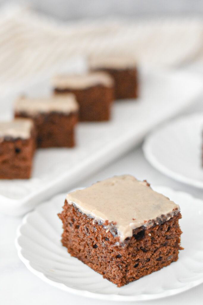 A slice of moist gingerbread snacking cake with maple icing