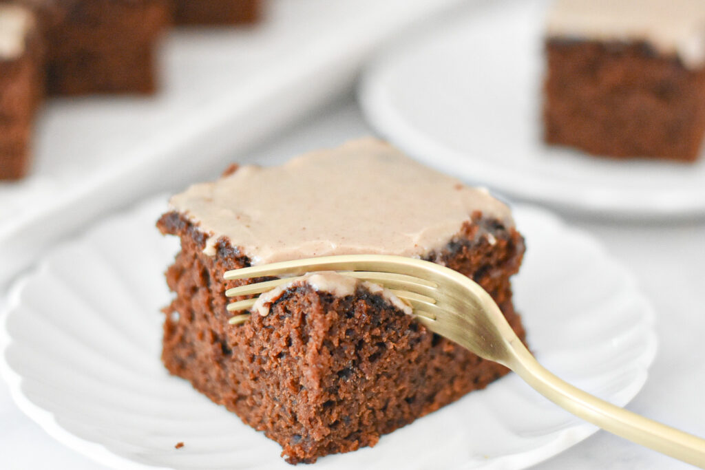 A slice of moist gingerbread snacking cake with maple icing