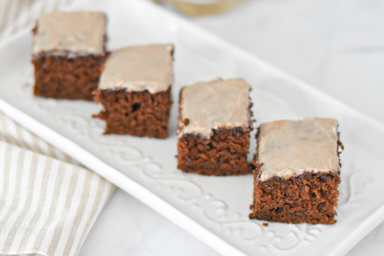 A slice of moist gingerbread snacking cake with maple icing