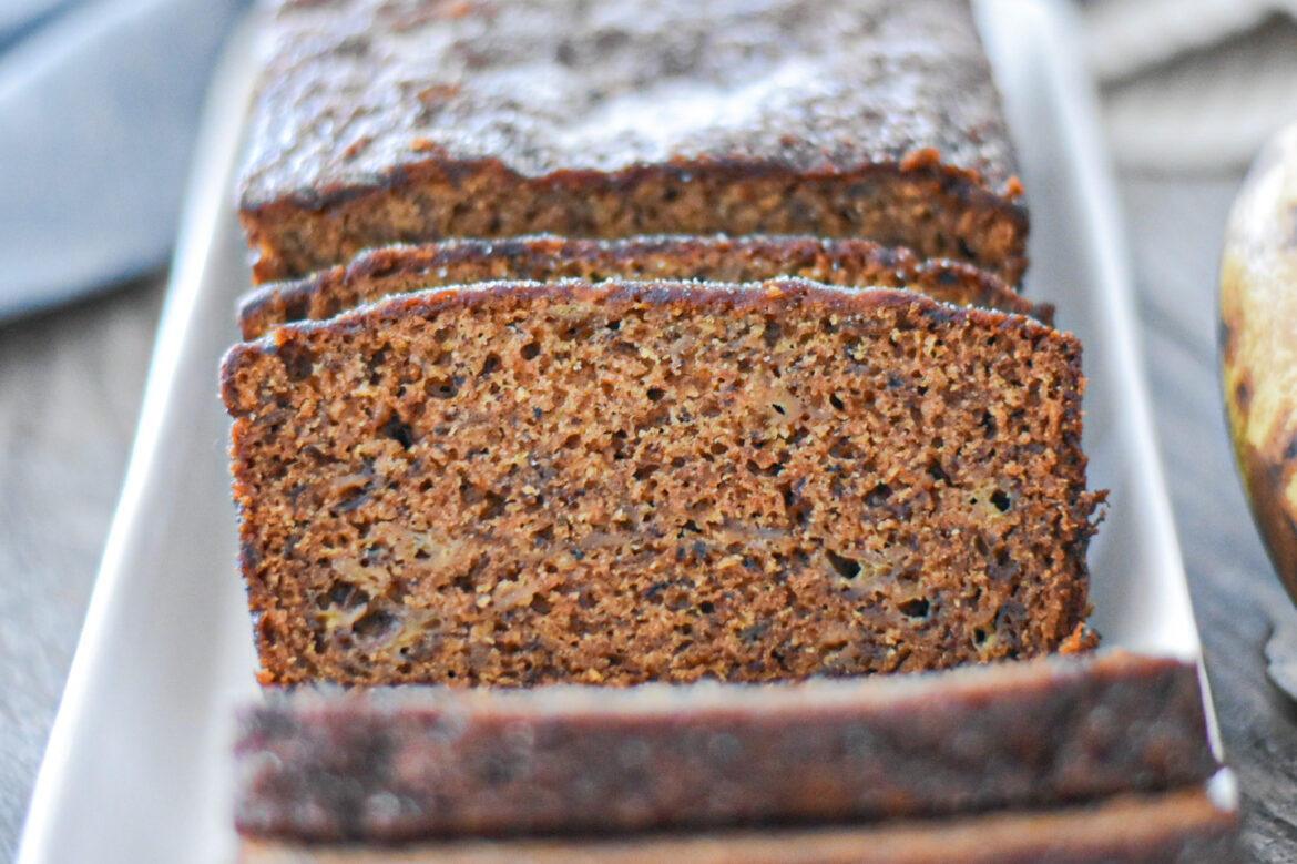 Banana bread on a platter, near a banana