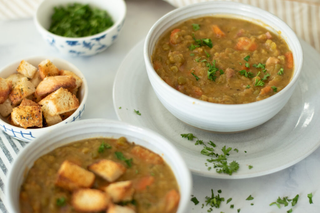 split pea and ham soup in bowls with fresh croutons