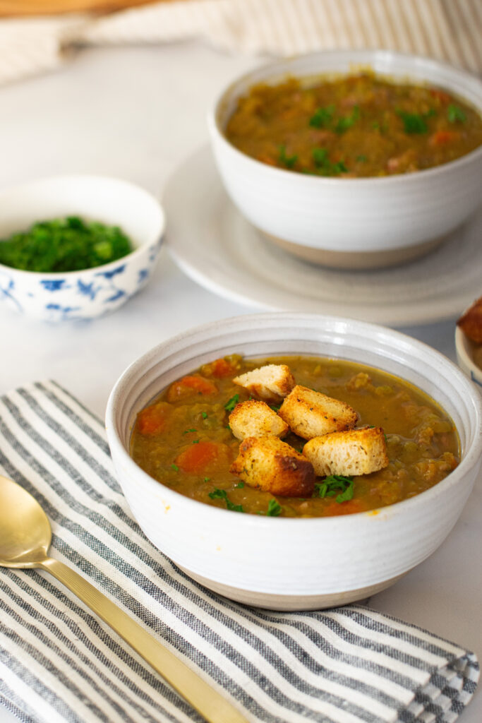 split pea and ham soup in bowls with fresh croutons