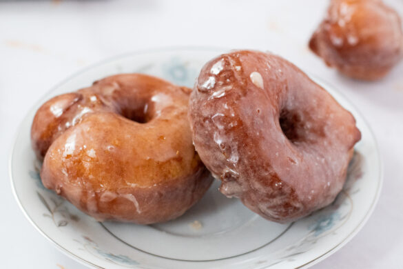 fluffy yeasted potato donuts with maple vanilla glaze on a plate