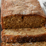 Top-down view of a golden-brown apple cider loaf cake, evenly dusted with cinnamon sugar for a perfect fall treat.