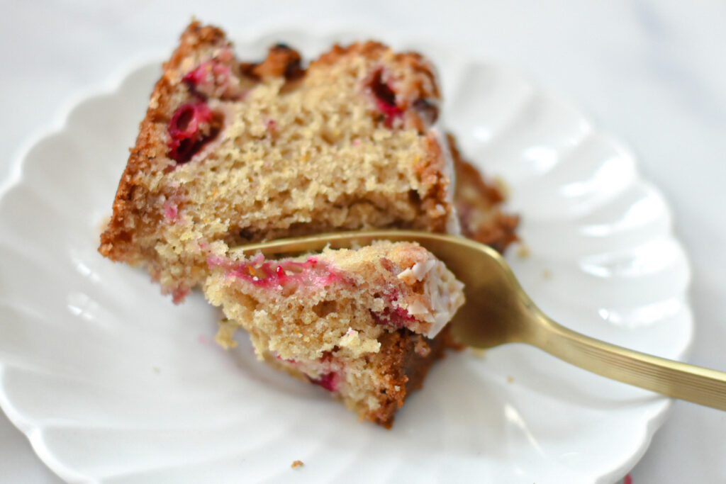 slice of cranberry orange bread with fork about to eat