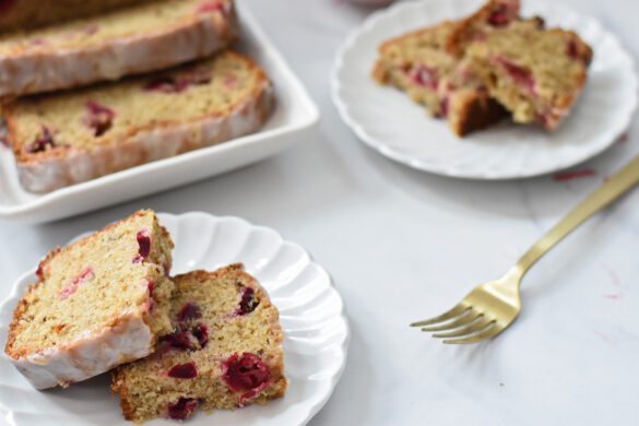 Cranberry orange bread with maple glaze on a plate