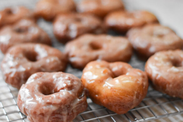 Fluffy yeast raised potato donuts on a cooling rack